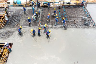 construction worker pouring concrete by pumping